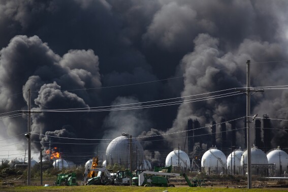 FILE - Smoke from an explosion at the TPC Group plant is seen Wednesday, Nov. 27, 2019, in Port Neches, Texas. The Texas petrochemical company has pleaded guilty to a violation of the Clean Air Act and has agreed to pay more than $30 million related to two explosions in 2019 at their facility in Port Neches, which caused the evacuation of thousands and injured workers, the U.S. Justice Department said Tuesday, May 21, 2024. (Marie D. De Jesús//Houston Chronicle via AP, File)
