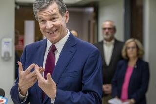 North Carolina Governor Roy Cooper speaks to the gathered media after a tour of the COVID-19 vaccine at the Davidson County Health Department in Lexington, N.C., on Thursday, June 17, 2021. (Woody Marshall/News & Record via AP)