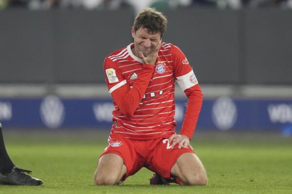 Bayern's Thomas Mueller grimaces after challenging for the ball during the German Bundesliga soccer match between VfL Wolfsburg and FC Bayern Munich in Wolfsburg, Germany, Sunday, Feb. 5, 2023. (AP Photo/Michael Sohn)