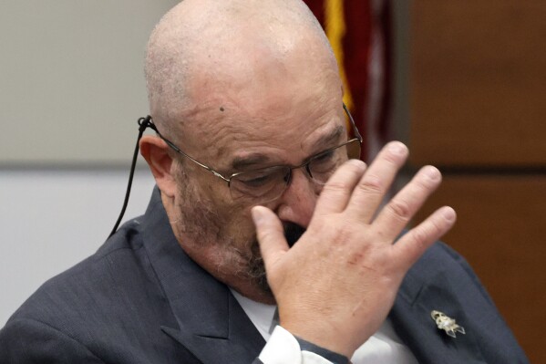 Broward Sheriff's Office Detective John Curcio becomes emotional while testifying during the trial of former Marjory Stoneman Douglas High School School Resource Officer Scot Peterson at the Broward County Courthouse in Fort Lauderdale, Fla., on Wednesday, June 21, 2023. Broward County prosecutors charged Peterson, a former Broward Sheriff's Office deputy, with criminal charges for failing to enter the 1200 Building at the school and confront the shooter. (Amy Beth Bennett/South Florida Sun-Sentinel via AP, Pool)
