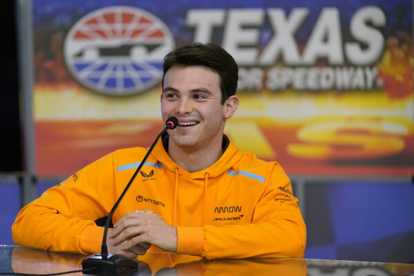 FILE - IndyCar Series driver Pato O'Ward, of Mexico, laughs as he speaks to reporters at Texas Motor Speedway in Fort Worth, Texas, Wednesday, March 15, 2023. O'Ward signed a multi-year extension with McLaren Racing, the IndyCar team announced Friday, March 1, 2024. The 24-year-old Mexican driver is entering his fifth full season in IndyCar, all with Arrow McLaren, and late last year was named McLaren's reserve driver for its Formula 1 team. (AP Photo/LM Otero, File)