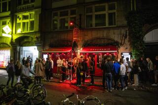 FILE - People wait in front of La Boucherie on Vestergade in Copenhagen on the night between Thursday, Sept. 2 and Friday, Sept. 3, 2021. Denmark's government has ordered nightclubs, bars and restaurants to close at midnight in an attempt to counter an uptick in COVID-19 cases it was announced on Thursday, Dec. 9, 2021. Prime Minister Mette Frederiksen said students up to the 10th grade must study remotely for the last few days before Christmas break and banned concerts where the audiences have more than 50 people standing. (Olafur Steinar Gestsson/Ritzau Scanpix via AP, File)