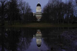 FILE - The Maine State House is seen at dawn from Capitol Park on Dec. 2, 2020, in Augusta, Maine. Democratic leaders in the Maine Legislature were prepared Thursday, March 30, 2023, to push through a $9.8 billion, two-year state budget that’ll ensure there’s no government shutdown this summer. (AP Photo/Robert F. Bukaty, File)