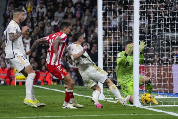 Real Madrid's Dani Carvajal, second right, scores his side's third goal during a Spanish La Liga soccer match between Real Madrid and Almeria at the Santiago Bernabeu stadium in Madrid, Spain, Sunday, Jan. 21, 2024. (AP Photo/Bernat Armangue )