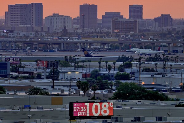 FILE - The unofficial temperature hits 108 degrees at dusk at Sky Harbor International Airport in Phoenix on July 12, 2023. Phoenix saw 20 consecutive days of extreme heat stress in July, the longest run of such dangerously hot days in the city since at least 1940, according to the data from the Copernicus Climate Change Service. The death certificates of more than 2,300 people who died in the United States last summer mention the effects of excessive heat, the highest number in 45 years of records, according to an Associated Press analysis of Centers for Disease Control and Prevention data. With May already breaking heat records, 2024 could be even deadlier. (AP Photo/Matt York, File)