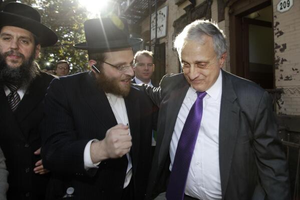 Rabbi Yechezkel Roth, left, and another Orthodox Jewish supporter, center, accompany New York Republican gubernatorial candidate Carl Paladino in the Williamsburg neighborhood of the Brooklyn borough of New York, after Paladino made campaign stops at the K'Hal Aadas Kasho synagogue, Sunday, Oct. 10, 2010. (AP Photo/Kathy Willens)
