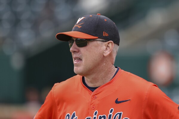 Virginia head coach Brian O'Connor talks with officials before an NCAA baseball game against Wichita State, Friday, Feb. 23, 2024, in Jacksonville, Fla. (AP Photo/Gary McCullough, File)