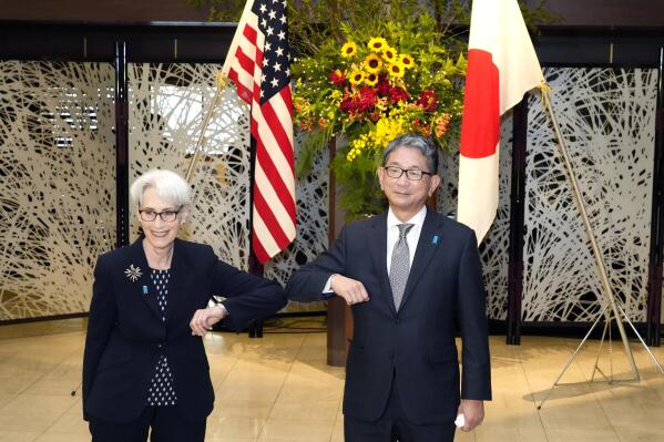 U.S. Deputy Secretary of State Wendy Sherman, left, elbow bumps with Japanese Vice-Minister for Foreign Affairs Takeo Mori, right, prior to their meeting at the Iikura Guesthouse Tuesday, July 20, 2021, in Tokyo. (AP Photo/Eugene Hoshiko, Pool)