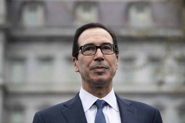 FILE - Former Treasury Secretary Steve Mnuchin speaks with reporters at the White House, March 13, 2020, in Washington. Mnuchin is interested in buying TikTok, just days after his investment firm led a $1 billion deal to inject life into a beaten-down bank.(AP Photo/Alex Brandon, File)