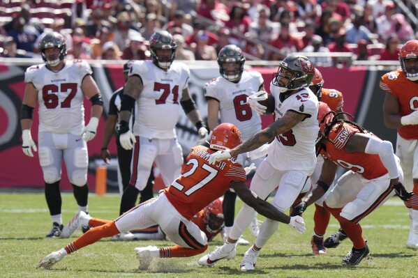 Tampa Bay Buccaneers wide receiver Mike Evans (13) is stopped by Chicago Bears cornerback Greg Stroman Jr. (27) during the second half of an NFL football game, Sunday, Sept. 17, 2023, in Tampa, Fla. (AP Photo/Chris O'Meara)