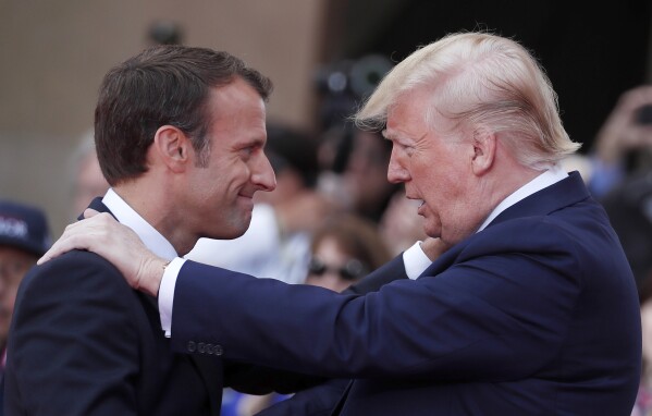 French President Emmanuel Macron, left, meets U.S President Donald Trump during a ceremony to mark the 75th anniversary of D-Day at the Normandy American Cemetery in Colleville-sur-Mer, Normandy, France, on June 6, 2019. (Ian Langsdon/Pool via AP, File)