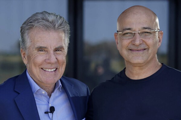 This 2019 photo provided by Cellebrite DI, National Center for Missing & Exploited Children Co-Founder John Walsh (left) and Cellebrite DI Co-Founder Yossi Carmil meet in Israel in 2019. Cellebrite will donate money and its digital tools to nonprofits helping missing and exploited children as part of its 