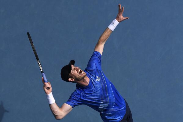 Andy Murray of Britain serves to Nikoloz Basilashvili of Georgia during their first round match at the Australian Open tennis championships in Melbourne, Australia, Tuesday, Jan. 18, 2022. (AP Photo/Andy Brownbill)