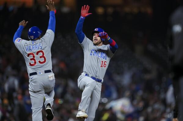 Chicago Cubs' Patrick Wisdom (16) celebrates with third base coach Willie Harris (33) after hitting a solo home run against the San Francisco Giants during the fifth inning of a baseball game in San Francisco, Friday, July 29, 2022. (AP Photo/Godofredo A. Vásquez)