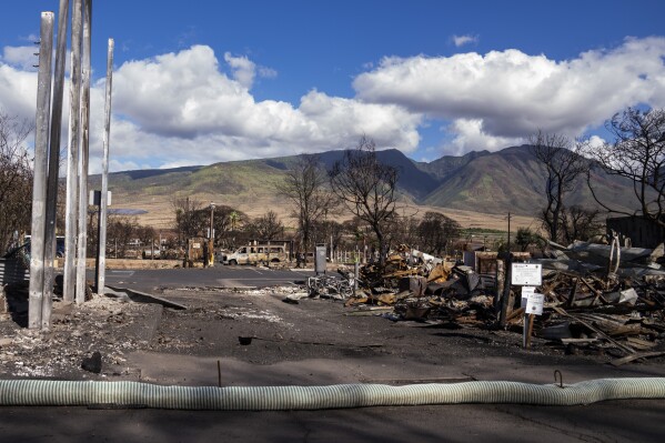 FILE - Debris of former shops and businesses on Front Street in burn zone 11A lays strewn, Dec. 8, 2023, in Lahaina, Hawaii. Hawaii Gov. Josh Green said Tuesday, Feb, 27, 2024, a $175 million fund to compensate families of people killed in the deadliest U.S. wildfire in more than a century will begin accepting applications at the end of the week. The fund for Maui wildfire victims will also pay those who were hospitalized with severe injuries. (AP Photo/Lindsey Wasson, File)