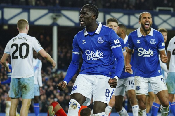 Everton's Amadou Onana, front, celebrates after scoring his side's first goal during the English Premier League soccer match between Everton and Crystal Palace at the Goodison Park stadium, in Liverpool, England, Monday, Feb. 19, 2024. (Peter Byrne/PA via AP)