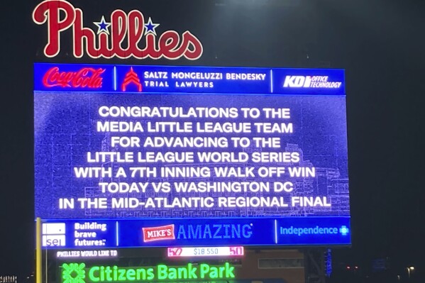 A screen shows a message of congratulations for the Little League team from Media, Pa., during the baseball game between the Minnesota Twins and the Philadelphia Phillies on Friday, Aug. 11, 2023, in Philadelphia. Media is heading to the Little League World Series after a 2-0 victory Friday over Northwest Washington, D.C., in the Mid-Atlantic Regional championship in Bristol, Conn. (AP Photo/Dan Gelston)