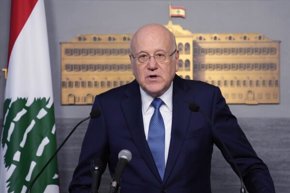 FILE - Lebanese caretaker Prime Minister Najib Mikati, speaks at the government palace, in Beirut, Lebanon, Monday, March 27, 2023. Mikati is warning, Thursday, Sept. 7, that Syrian refugees could become a threat to the small Mediterranean nation’s delicate demographic and sectarian balance. Over a thousand Syrian refugees each week are fleeing to Lebanon from their country’s worsening economic and financial conditions. (AP Photo/Hussein Malla, File)