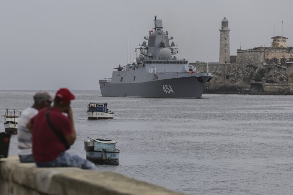 People watch the Russian Navy Admiral Gorshkov frigate arrive at the port of Havana, Cuba, Wednesday, June 12, 2024. A fleet of Russian warships reached Cuban waters on Wednesday ahead of planned military exercises in the Caribbean. (AP Photo/Ariel Ley)