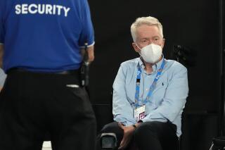 Australian Open tournament director Craig Tiley watches the fourth round match between Stefanos Tsitsipas of Greece and Taylor Fritz of the U.S. at the Australian Open tennis championships in Melbourne, Australia, early Tuesday, Jan. 25, 2022. (AP Photo/Simon Baker)