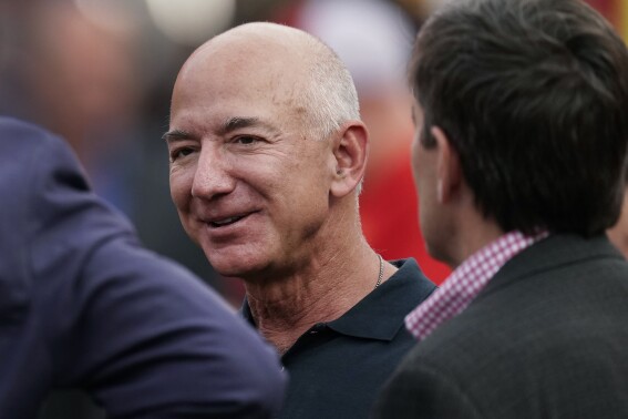 FILE - Amazon founder Jeff Bezos is seen on the sidelines before the start of an NFL football game, Sept. 15, 2022, in Kansas City, Mo. The founder of Amazon is buying a home on an exclusive barrier island in Miami where he'll be neighbors with Tom Brady, Ivanka Trump and her husband, Jared Kushner. (AP Photo/Charlie Riedel, File)