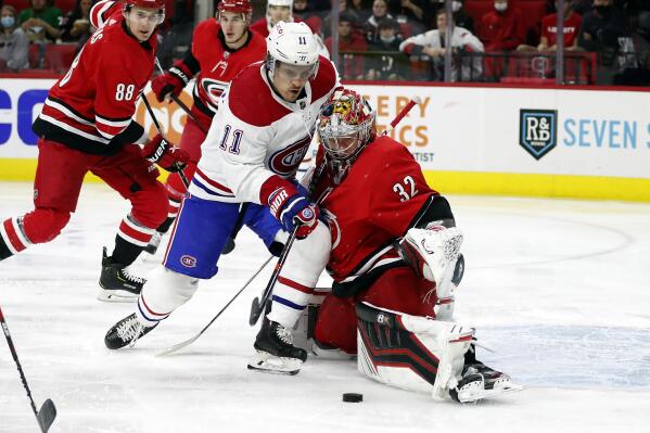 Montreal Canadiens' Brendan Gallagher (11) has his shot blocked by Carolina Hurricanes goaltender Antti Raanta (32) during the first period of an NHL hockey game in Raleigh, N.C., Thursday, Dec. 30, 2021. (AP Photo/Karl B DeBlaker)