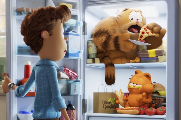 This image released by Sony Pictures shows characters Jon, voiced by Nicholas Hoult, clockwise from left, Vic, voiced by Samuel L. Jackson, and Garfield, voiced by Chris Pratt, in a scene from the animated film "The Garfield Movie." (Columbia Pictures/Sony via AP)
