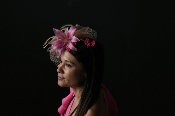 A race fan walk through a tunnel at Churchill Downs before the 151st running of the Kentucky Oaks horse race Friday, May 2, 2025, in Louisville, Ky. (AP Photo/Brynn Anderson)
