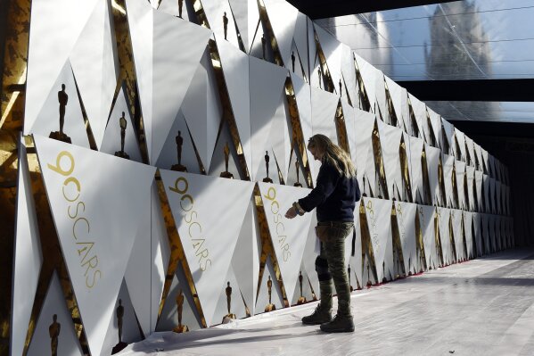 Scenic artist Dena D'Angelo inspects the backdrop for the arrivals area before the rollout of the red carpet for Sunday's 90th Academy Awards in front of the Dolby Theatre on Wednesday, Feb. 28, 2018, in Los Angeles. (Photo by Chris Pizzello/Invision/AP)