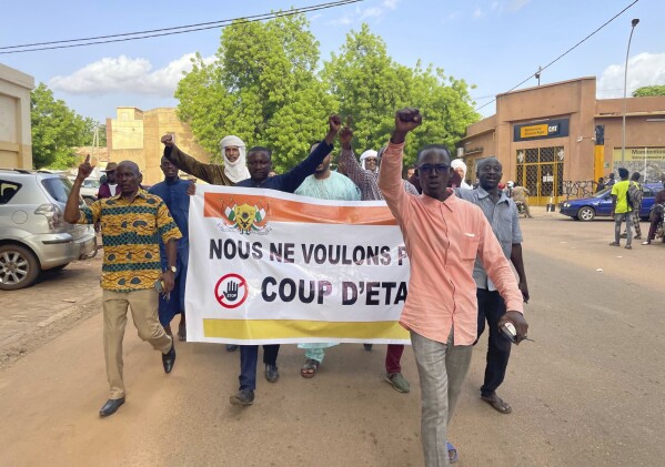 Supporters of Nigerien President Mohamed Bazoum demonstrate in his support in Niamey, Niger, Wednesday July 26, 2023. Governing bodies in Africa condemned what they characterized as a coup attempt Wednesday against Niger's president, whose official Twitter account reported that elements of the presidential guard engaged in an "anti-Republican demonstration" and tried to obtain the support of other security forces. (AP Photo/Sam Mednick)