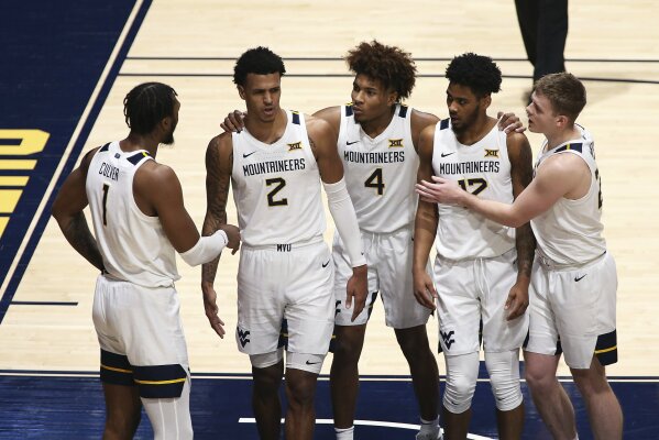 West Virginia forward Derek Culver (1), forward Jalen Bridges (2), guards Miles McBride (4), Taz Sherman (12), and Sean McNeil (22) gather on the court after a foul was called against West Virginia during the second half of an NCAA college basketball game against Texas Saturday, Jan. 9, 2021, in Morgantown, W.Va. (AP Photo/Kathleen Batten)