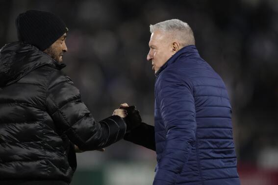 Colorado Rapids coach Robin Fraser, left, greets Sporting Kansas City coach Peter Vermes at an MLS soccer match Saturday, March 4, 2023, in Commerce City, Colo. (AP Photo/David Zalubowski)