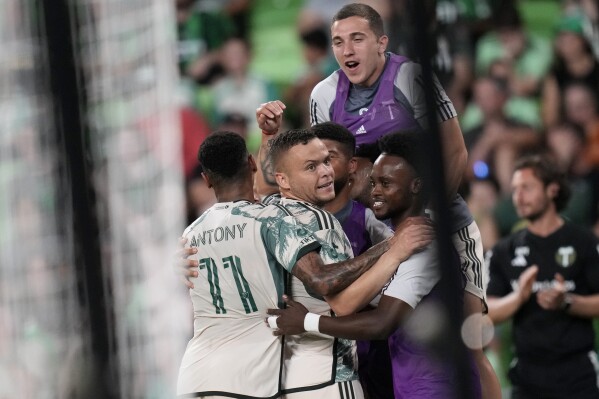 Portland Timbers forward Jonathan Rodríguez, center, celebrates his score against Austin FC during the second half of an MLS soccer match in Austin, Texas, Wednesday, May 29, 2024. (AP Photo/Eric Gay)