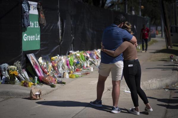 FILE - Two people who knew an unidentified victim of a fatal incident at the Houston Astroworld concert embrace at a memorial on Sunday, Nov. 7, 2021. A new task force will look into how to improve the safety at large Houston-area events in the hopes of avoiding another tragedy like last year's deadly Astroworld music festival, officials said Wednesday, Feb. 9, 2022. (AP Photo/Robert Bumsted, File)