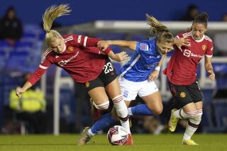 From left, Manchester United's Alessia Russo, Birmingham City's Veatriki Sarri, and Manchester United's Ona Batlle battle for the ball during the FA Women's Super League match at St. Andrew's, Birmingham, England, Sunday, Oct. 3, 2021. (David Davies/PA via AP)