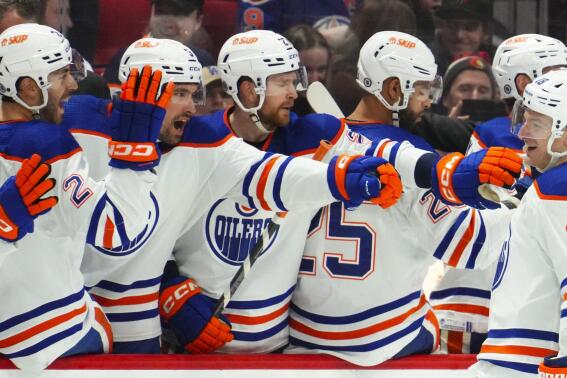 Edmonton Oilers left wing Zach Hyman (18) celebrates a goal with teammates on the bench during the second period of an NHL hockey game against the Ottawa Senators in Ottawa on Saturday, Feb. 11, 2023. (Sean Kilpatrick/The Canadian Press via AP)