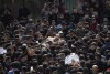 Mourners carry the bodies of six Palestinians during their funeral in Faraa refugee camp, West Bank, Friday, Dec. 8, 2023. The Palestinian Health Ministry says that six Palestinians were killed when Israeli forces raided the camp prompting fighting with local militants. (AP Photo/Majdi Mohammed)