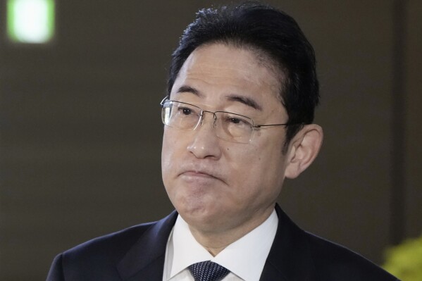 Japanese Prime Minister Fumio Kishida answers to reporters at his office in Tokyo Monday, Dec. 11, 2023. Prime Minister Kishida said Monday he planned to take “appropriate steps” over his governing party’s widening slush funds scandal as speculation is rife that he may purge implicated Cabinet members in a major shuffle this week.(Kyodo News via AP)