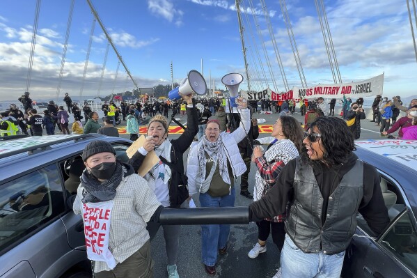 FILE - Demonstrators shut down the San Francisco Oakland Bay Bridge in conjunction with the APEC Summit taking place Thursday, Nov. 16, 2023, in San Francisco. Seventy-eight protesters were ordered Thursday, March 14, 2024, do five hours of community service and pay restitution to avoid criminal proceedings for allegedly blocking traffic on the San Francisco-Oakland Bay Bridge for hours in November to demand a cease-fire in Gaza, prosecutors said. (AP Photo/Noah Berger, File)