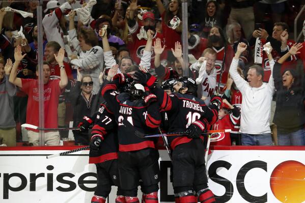 The Carolina Hurricanes celebrate a goal by Teuvo Teravainen against the New York Rangers during the second period of Game 5 of an NHL hockey Stanley Cup second-round playoff series in Raleigh, N.C., Thursday, May 26, 2022. (AP Photo/Karl B DeBlaker)