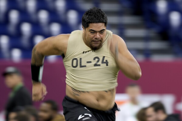 FILE - Oregon State offensive lineman Taliese Fuaga runs the 40-yard dash during the NFL football scouting combine, Sunday, March 3, 2024, in Indianapolis. Fuaga has been mentioned as a possible NFL Draft first round pick by the Cincinnati Bengals. (AP Photo/Charlie Riedel, File)