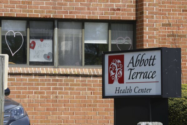 A sign for nursing home employees hangs in a window at the Abbott Terrace Health Center, Thursday, May 14, 2020 in Waterbury, Conn. The coronavirus has had no regard for health care quality or ratings as it has swept through nursing homes around the world, killing efficiently even in highly rated care centers. Preliminary research indicates the numbers of nursing home residents testing positive for the coronavirus and dying from COVID-19 are linked to location and population density — not care quality ratings. (AP Photo/Chris Ehrmann)