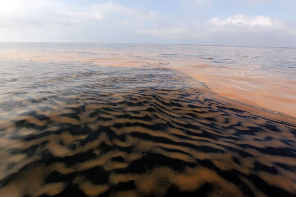 FILE - Oil makes a pattern in the waters of Chandeleur Sound, La., May 6, 2010. (AP Photo/Alex Brandon, File)