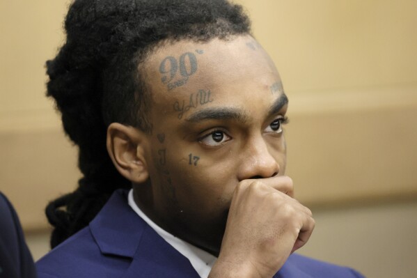 Jamell Demons, better known as rapper YNW Melly, is shown at the defense table as a question from the jury is read by the judge in his trial at the Broward County Courthouse in Fort Lauderdale, Fla., on Friday, July 21, 2023. Demons, 22, is accused of killing two fellow rappers and conspiring to make it look like a drive-by shooting in October 2018. (Amy Beth Bennett /South Florida Sun-Sentinel via AP)