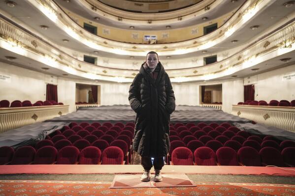 Yulia Marukhnenko, who was renting an apartment nearby the Donetsk Academic Regional Drama Theatre in Mariupol, Ukraine, poses for a photo in the Dnipro Academic Drama & Comedy Theatre in Dnipro, Ukraine, on Sunday, March 27, 2022. Following the March 16, 2022, bombing of the theater in Mariupol, Marukhnenko, trained in first aid, with a full kit on hand, was facing problems no first aid could begin to help: limbs, bodies with no limbs, bones sticking out. (AP Photo/Evgeniy Maloletka)