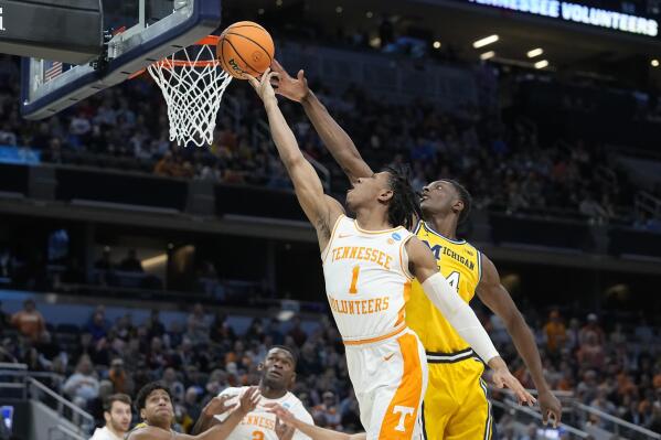 Tennessee's Kennedy Chandler (1) has his shot blocked by Michigan's Moussa Diabate (14) during the first half of a college basketball game in the second round of the NCAA tournament, Saturday, March 19, 2022, in Indianapolis. (AP Photo/Darron Cummings)