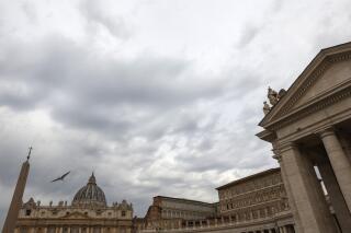 FILE - Clouds hang over St. Peter's Square at the Vatican on July 27, 2021. Lawyers for defendants in a big Vatican financial trial asked the Holy See newspaper on Friday, Dec. 24, 2021 to correct the record after it ran a front-page editorial this week largely defending the investigation and insisting that the rights of the defense are being protected. The letter to L’Osservatore Romano editor Andrea Monda was signed by eight defense attorneys and follows a Dec. 20 editorial penned by the Holy See’s editorial director, Andrea Tornielli. (AP Photo/Riccardo De Luca, File)
