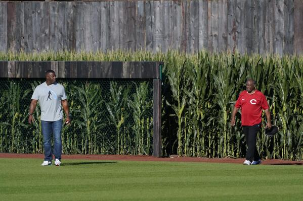 Ken Griffey Jr., left, and his father Jen Griffey Sr., walk on to the field before a baseball game between the Cincinnati Reds and Chicago Cubs at the Field of Dreams movie site, Thursday, Aug. 11, 2022, in Dyersville, Iowa. (AP Photo/Charlie Neibergall)