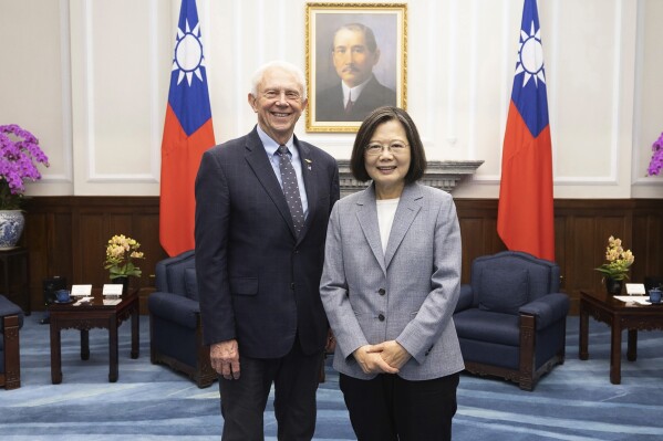 In this photo released by the Taiwan Presidential Office, Taiwan's President Tsai Ing-wen, right, poses for photos with Rep. Jack Bergman, R-Mich., in Taipei, Taiwan on Thursday, March 28, 2024. Bergman leads a bipartisan U.S. congressional delegation that pledged continued support for Taiwan on Thursday, days after Congress approved $300 million in military aid for the self-governed island that's claimed by China. (Taiwan Presidential Office via AP)