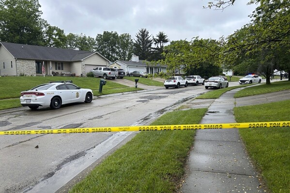 Indianapolis police investigate a shooting on Watercrest Way, were also involved in a shooting at a residence Wednesday, May 15, 2024, in Indianapolis. An Indianapolis police officer fatally shot a man Wednesday during an exchange of gunfire with the man, who was suspected in an earlier shooting, police said. (Jake Allen/The Indianapolis Star via AP)